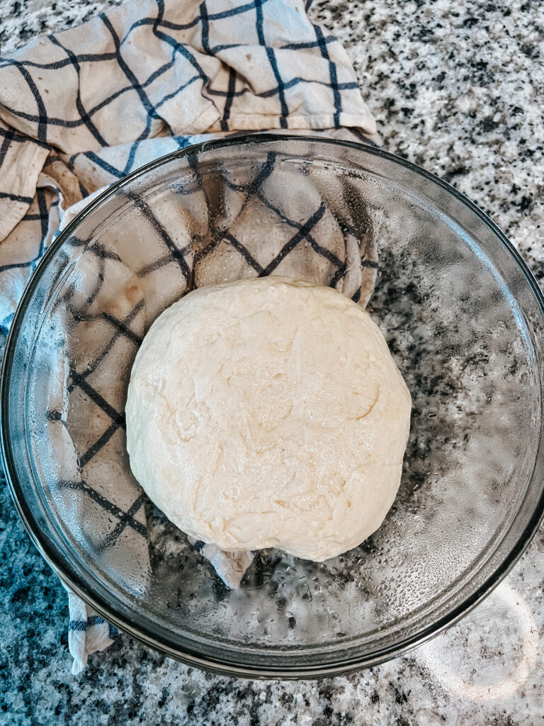 Overhead shot of sourdough cinnamon roll dough after kneading but before beginning its bulk fermentation
