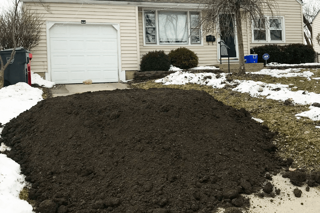 Photo of a large pile of soil at the foot of my driveway