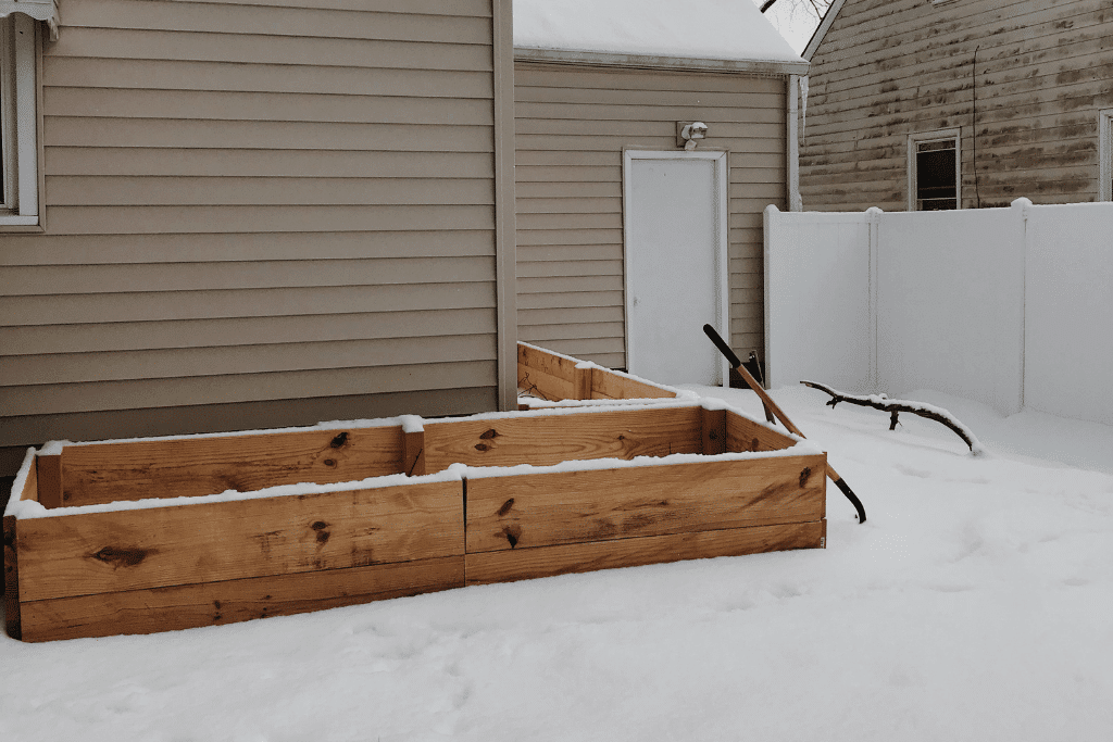 Photo of unfilled raised garden beds in the snow