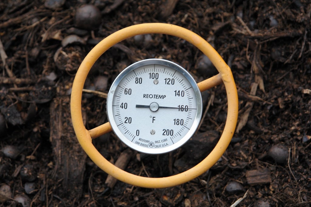 Image of a soil thermometer in a hot compost pile. The thermometer registers 160 degrees F.