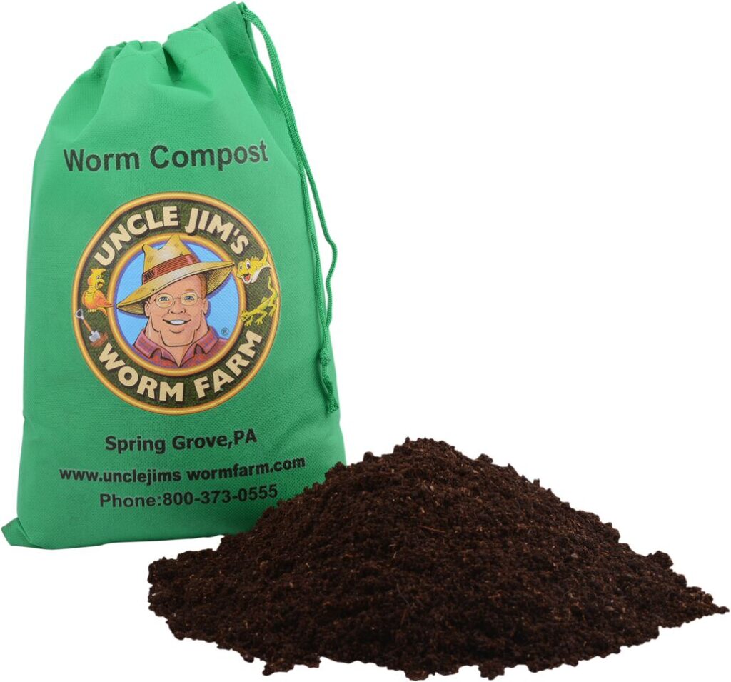 A green bag containing the label for Uncle Jim's Worm Farm Worm Compost and a pile of worm castings in the foreground feed the soil